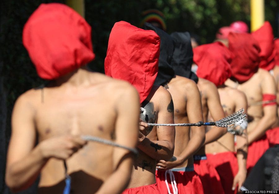 Hooded Filipino penitents flagellate during Maundy Thursday rituals to atone for sins on April 17, 2014, in suburban Mandaluyong, east of Manila, Philippines. The ritual is frowned upon by church leaders in this predominantly Roman Catholic country. (AP Photo/Aaron Favila)