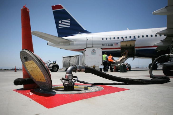 OAKLAND, CA - JULY 18:  A fuel line connected to an underground tank is seen near a US Airways plane July 18, 2008 at the Oakland International Airport in Oakland, California. US Airways pilots and its dispatchers, who calculate fuel loads, are involved in a dispute that has pilots claiming that they are being pressured to fly with less fuel to cut costs as fuel prices continue to rise and cripple earnings.  (Photo by Justin Sullivan/Getty Images)
