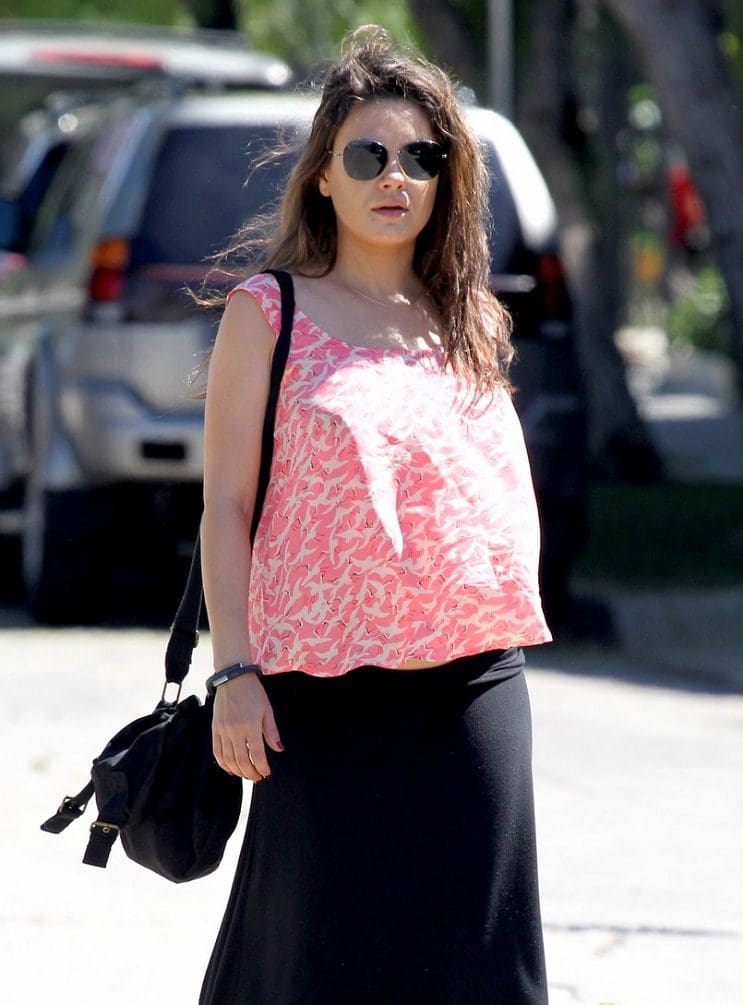 *EXCLUSIVE* Hollywood, CA - A glowing Mila Kunis looks relaxed and wears a cute loose fitting top over a black maxi skirt as she crosses the strewn in Hollywood.  The mommy-to-be exposed a flash of her baby bump as the breeze picked up, but she didn't seem to like the attention and gave the photographer and message. AKM-GSI          May 3, 2014 To License These Photos, Please Contact : Steve Ginsburg (310) 505-8447 (323) 423-9397 steve@akmgsi.com sales@akmgsi.com or Maria Buda (917) 242-1505 mbuda@akmgsi.com ginsburgspalyinc@gmail.com