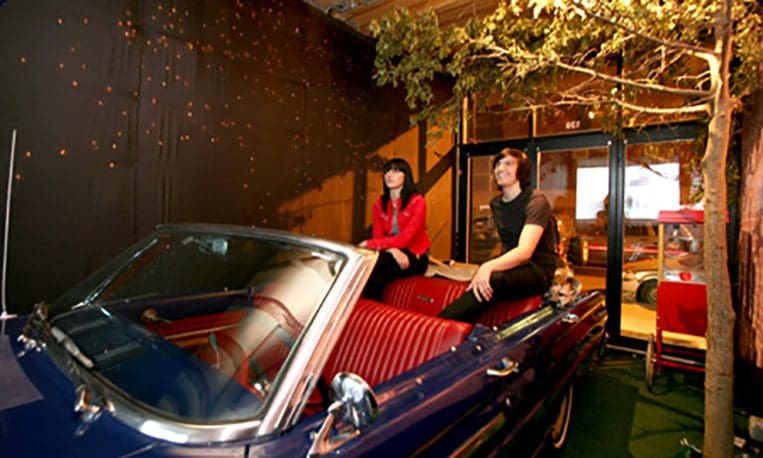 Artist Kevin Fey and his sister Lydia sit in a car and watch a movie in a storefront lounge, called DRV-IN, Saturday, September 15, 2007, in the Lower East Side of New York. The design space, called Grand Opening, is run by Canadian brothers Ben and Hall Smyth and will change concepts every three or four months. (Photo by Diane Bondareff for The Toronto Star)
