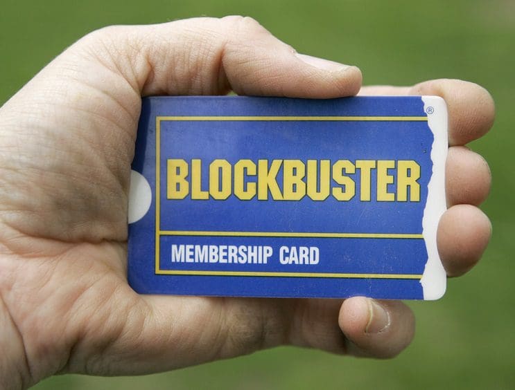 ** FILE ** In this May 9, 2008 file photo, a customer holds her membership card outside a Blockbuster video store in Woodmere, Ohio. Blockbuster Inc.'s second-quarter loss deepened Thursday, Aug. 7, 2008, but the struggling movie rental chain showed some signs of progress by wringing more revenue from its stores while lowering its costs. (AP Photo/Amy Sancetta, file)