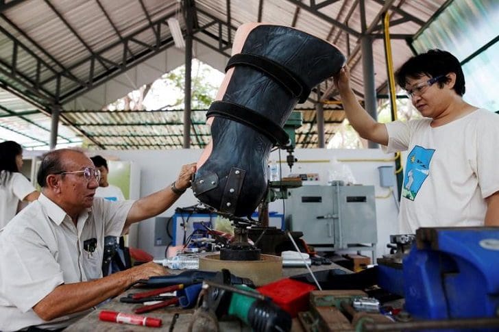 Engineer Boonyu Thippaya (L) and a member of his team adjust a prosthetic leg for an elephant, that was injured by a landmine, at the Friends of the Asian Elephant Foundation in Lampang, Thailand, June 29, 2016. REUTERS/Athit Perawongmetha